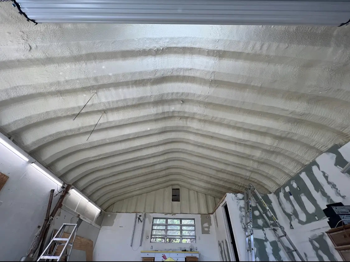 Spray polyurethane foam applied to the underside of a metal roof deck in Escalon